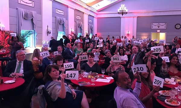 people holding numbers in auction